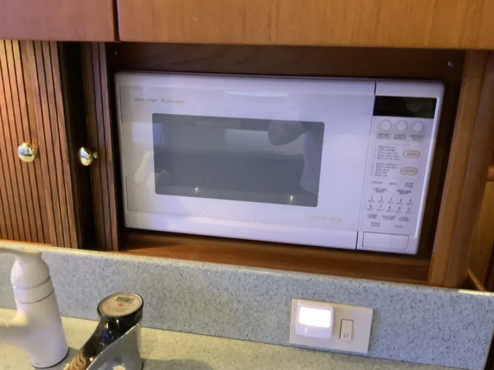 Bona Vida Yacht Photos Pics Built-in microwave in 1997 Ocean Yachts 48 Convertible kitchen area.