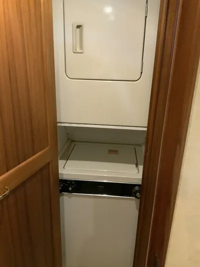 Bona Vida Yacht Photos Pics 1997 Ocean Yachts 48 Convertible yacht laundry area with stacked washer and dryer.