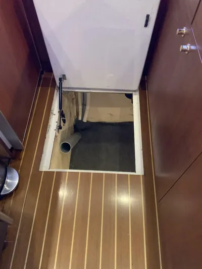 Bona Vida Yacht Photos Pics 1997 Ocean Yachts 48 Convertible interior with open floor hatch, revealing storage space.