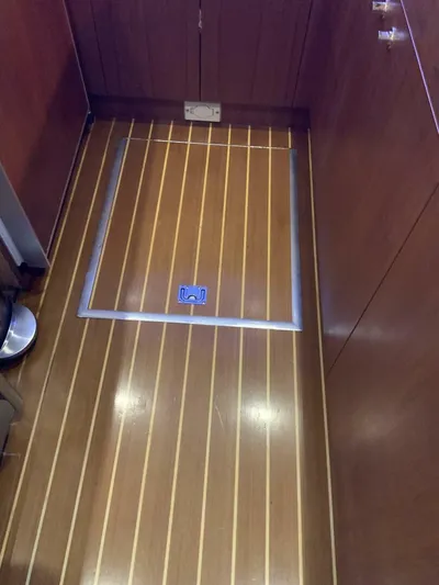 Bona Vida Yacht Photos Pics 1997 Ocean Yachts 48 Convertible interior with polished wooden flooring and storage hatch.