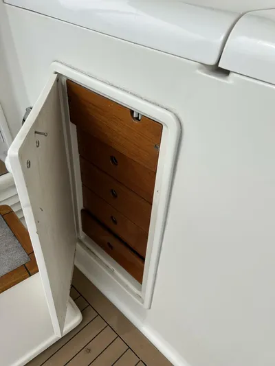 Bona Vida Yacht Photos Pics 1997 Ocean Yachts 48 Convertible, open storage compartment with wooden drawers.
