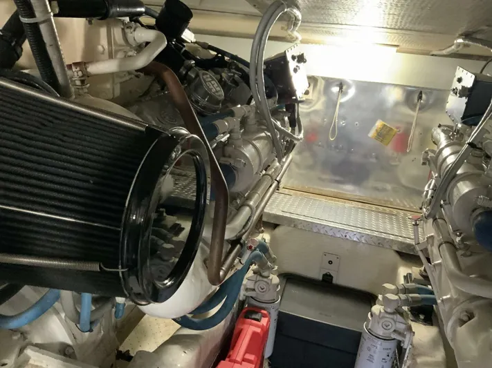 Bona Vida Yacht Photos Pics Engine room of 1997 Ocean Yachts 48 Convertible, showcasing dual engines and mechanical components.