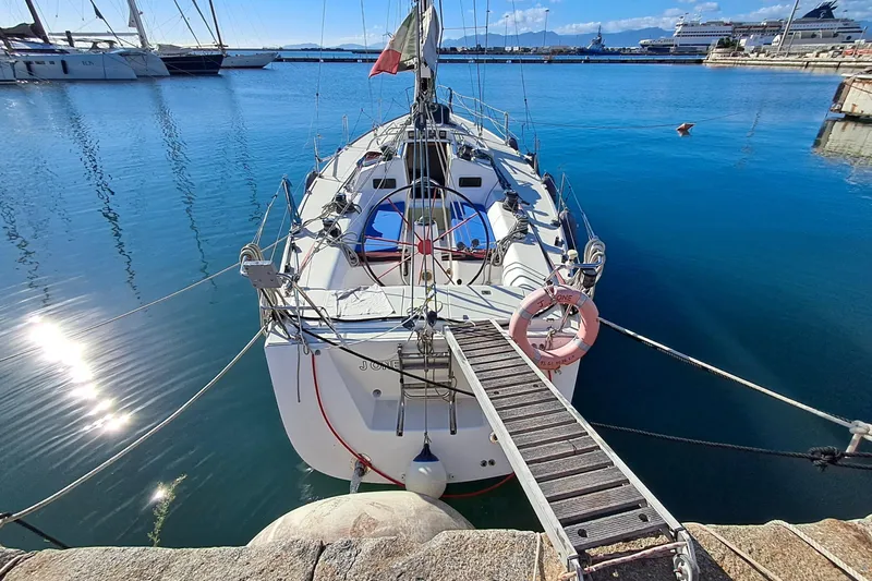  Yacht Photos Pics 1999 J Boats J/120 sailboat docked in a serene marina setting.