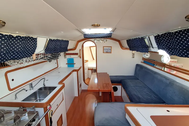  Yacht Photos Pics Interior of 1999 J Boats J/120 sailboat with cozy seating and kitchen area.