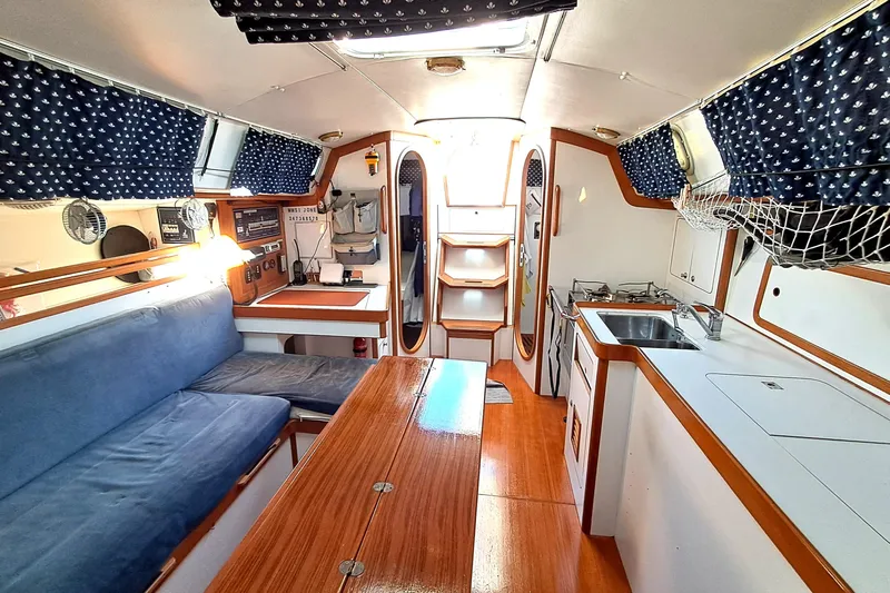  Yacht Photos Pics Interior of 1999 J Boats J/120 sailboat with cozy seating and kitchen area.