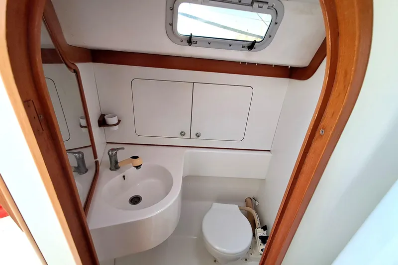  Yacht Photos Pics 1999 J Boats J/120 yacht bathroom with sink, toilet, and wooden trim.