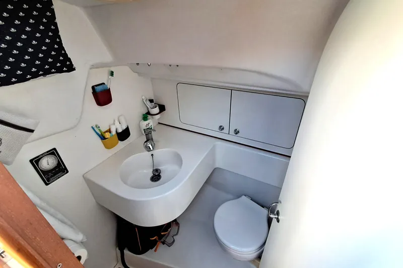  Yacht Photos Pics 1999 J Boats J/120 yacht bathroom with sink, toilet, and storage cabinets.