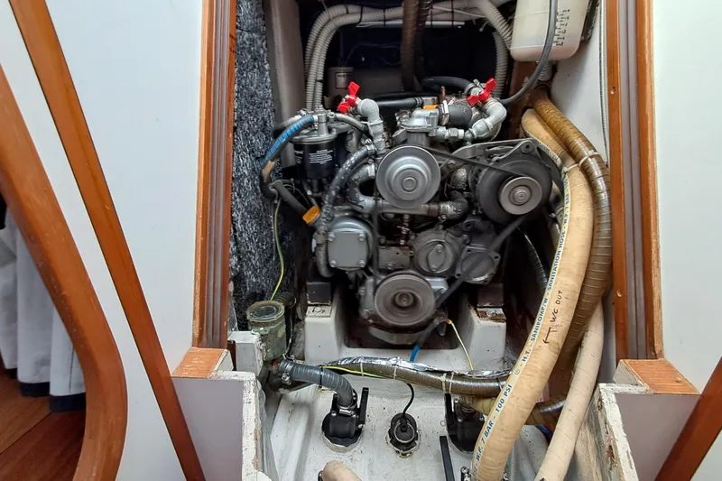  Yacht Photos Pics Engine compartment of a 1999 J Boats J/120 sailboat, showcasing mechanical components and hoses.