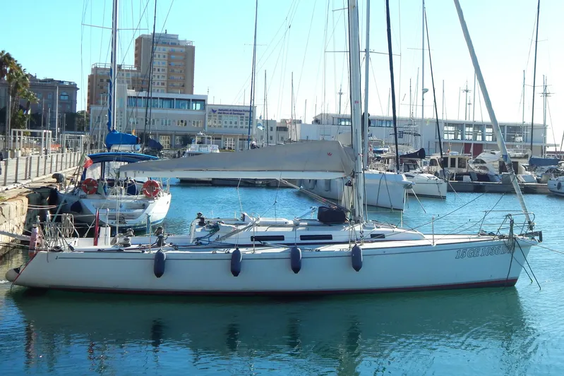 Yacht Photos Pics 1999 J Boats J/120 sailboat docked in a marina, surrounded by other vessels.