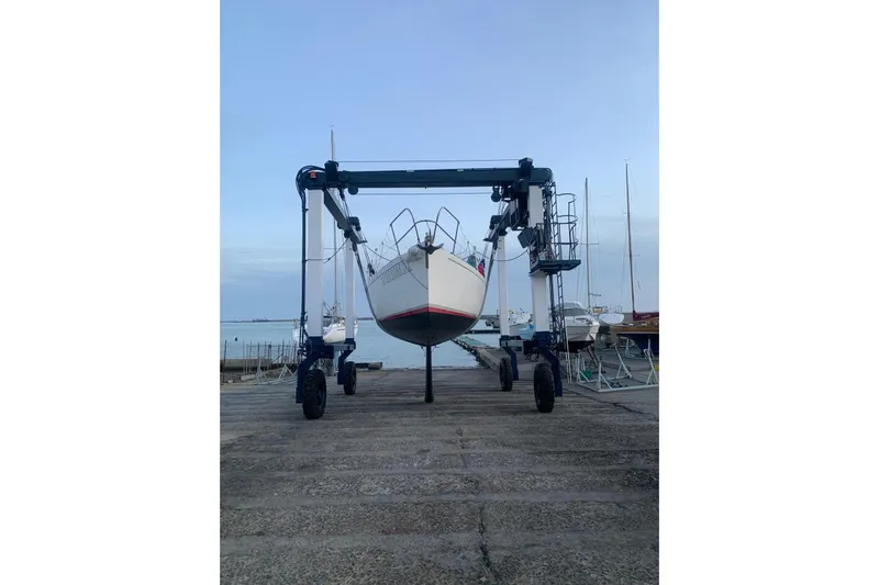  Yacht Photos Pics 1999 J Boats J/120 sailboat on a lift at a marina, ready for maintenance.