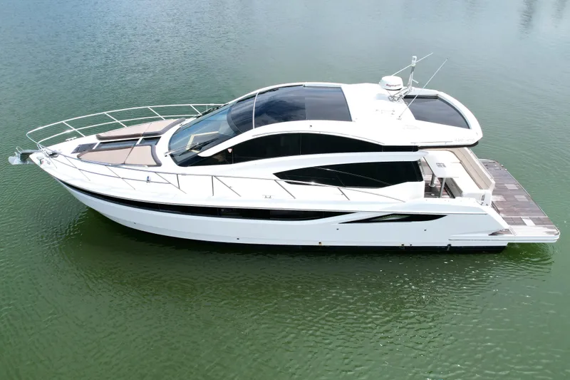 Makers Time Yacht Photos Pics 2018 Galeon 430 HTC yacht on calm water, sleek design, side view.