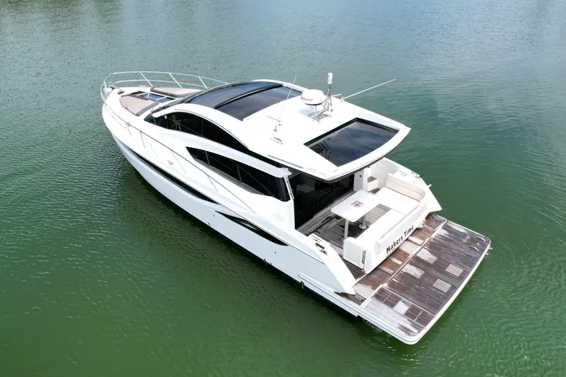 Makers Time Yacht Photos Pics 2018 Galeon 430 HTC yacht on calm water, showcasing sleek design and spacious deck.