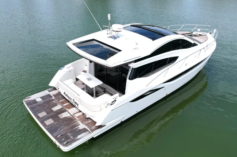 Makers Time Yacht Photos Pics 2018 Galeon 430 HTC luxury yacht on calm water, showcasing sleek design and spacious deck.