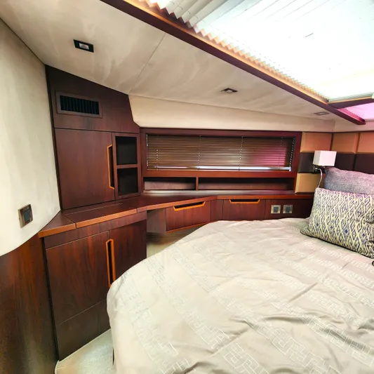 Makers Time Yacht Photos Pics Luxurious interior of 2018 Galeon 430 HTC yacht with elegant wood cabinetry and cozy bedding.