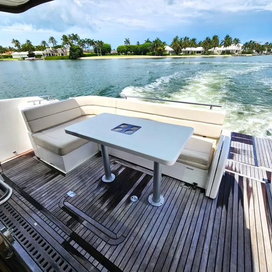 Makers Time Yacht Photos Pics Outdoor seating area on 2018 Galeon 430 HTC yacht, with scenic waterfront view.