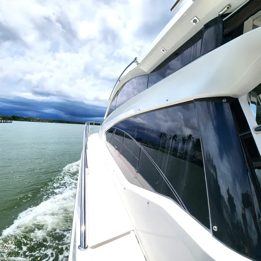Makers Time Yacht Photos Pics 2018 Galeon 430 HTC yacht cruising on a scenic waterway under cloudy skies.