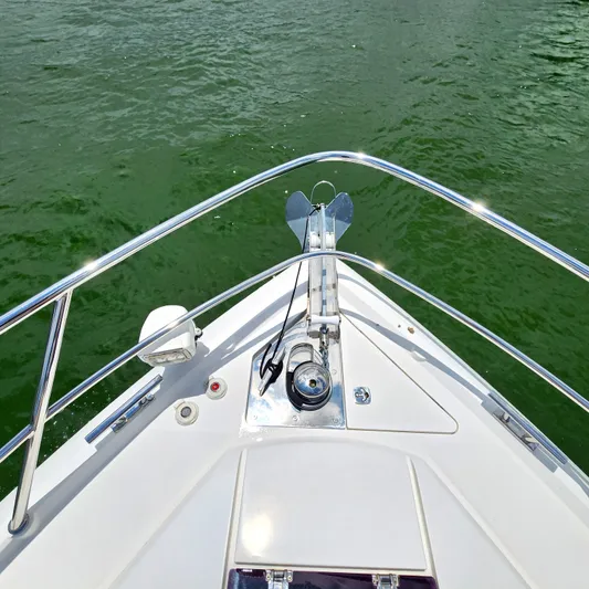 Makers Time Yacht Photos Pics Bow of 2018 Galeon 430 HTC yacht with anchor, on green water.