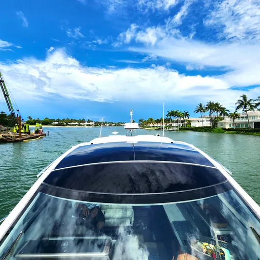 Makers Time Yacht Photos Pics 2018 Galeon 430 HTC yacht cruising on a scenic waterway under a vibrant blue sky.