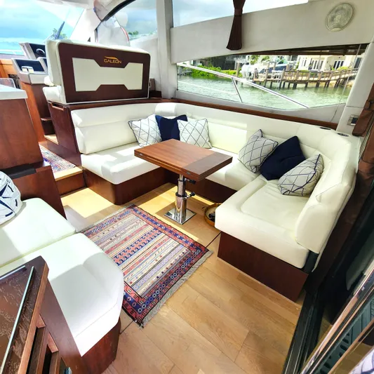 Makers Time Yacht Photos Pics Luxurious interior of 2018 Galeon 430 HTC yacht with white seating and wooden accents.