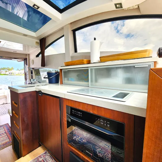 Makers Time Yacht Photos Pics Luxurious kitchen interior of 2018 Galeon 430 HTC yacht with modern appliances and scenic view.