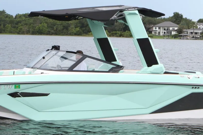  Yacht Photos Pics 2024 Nautique Super Air Nautique G23 boat on a lake, featuring sleek design and modern features.