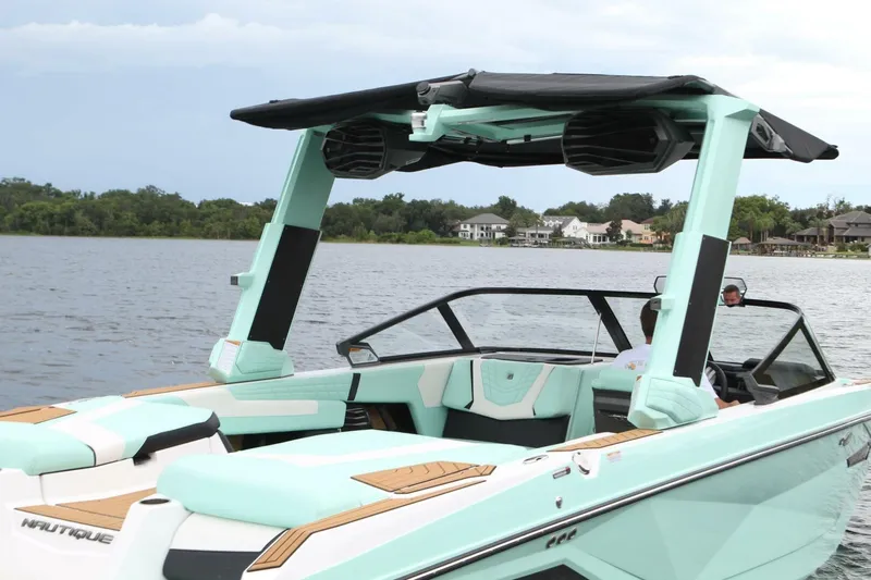  Yacht Photos Pics 2024 Nautique Super Air Nautique G23 boat on a lake, featuring sleek design and modern amenities.