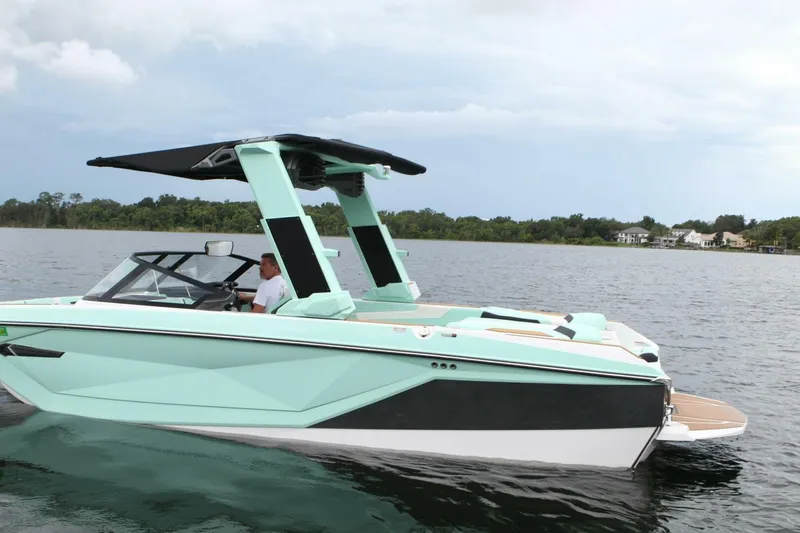  Yacht Photos Pics 2024 Nautique Super Air Nautique G23 boat on a lake, featuring sleek design and modern features.