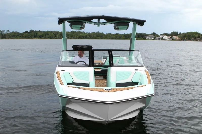  Yacht Photos Pics 2024 Nautique Super Air Nautique G23 boat on water, featuring sleek design and modern amenities.