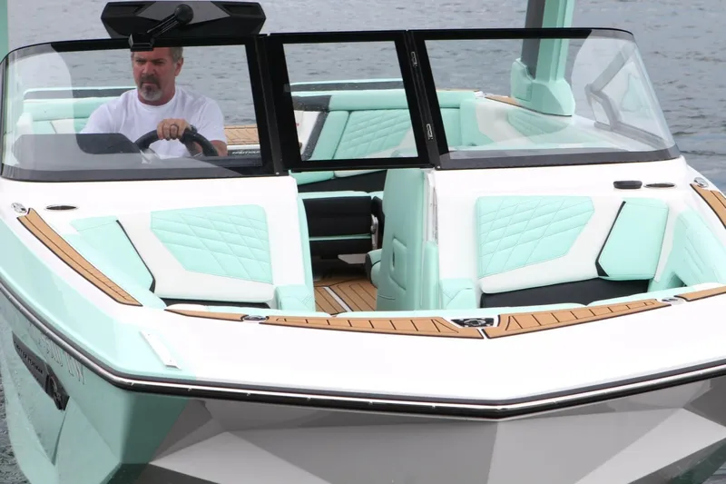  Yacht Photos Pics 2024 Nautique Super Air Nautique G23 boat with mint green interior on water.