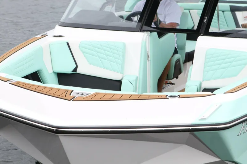  Yacht Photos Pics 2024 Nautique Super Air Nautique G23 boat with mint green interior and teak accents.