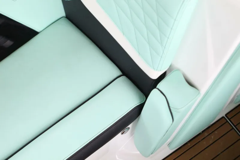  Yacht Photos Pics 2024 Nautique Super Air Nautique G23 interior with mint green upholstery and black accents.
