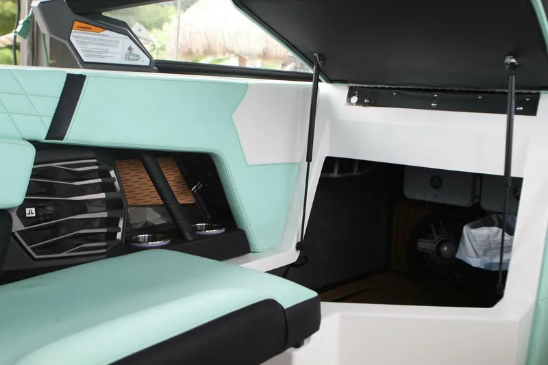  Yacht Photos Pics 2024 Nautique Super Air Nautique G23 interior with mint green upholstery and storage compartment.