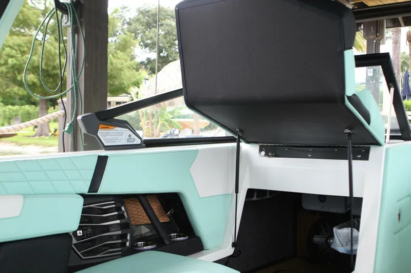  Yacht Photos Pics 2024 Nautique Super Air Nautique G23 interior with mint green upholstery and storage compartment.