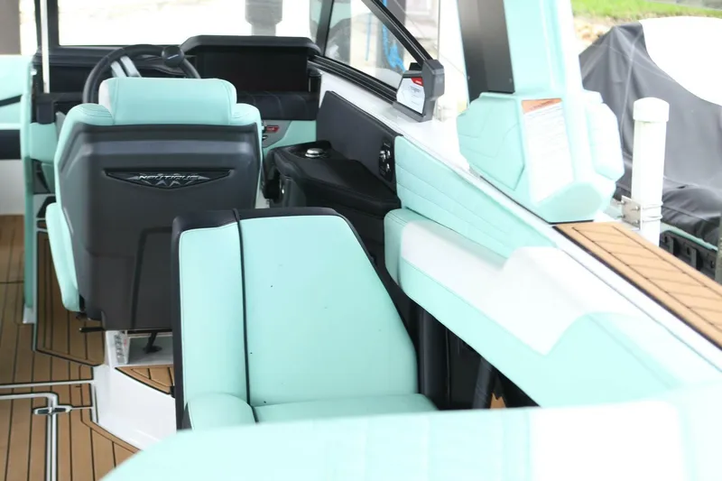  Yacht Photos Pics 2024 Nautique Super Air Nautique G23 interior with mint green and black seating.
