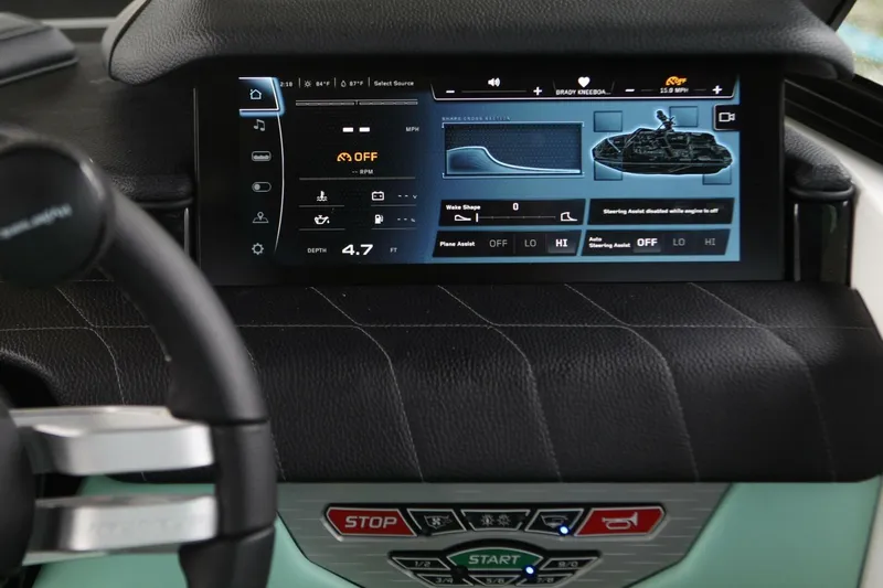  Yacht Photos Pics 2024 Nautique Super Air Nautique G23 dashboard with digital display and controls.