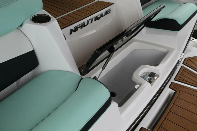  Yacht Photos Pics 2024 Nautique Super Air Nautique G23 interior with open storage compartment and teal seating.