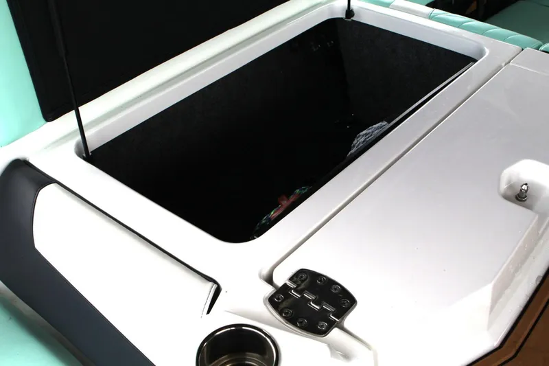  Yacht Photos Pics 2024 Nautique Super Air Nautique G23 storage compartment with cup holder and hinge detail.