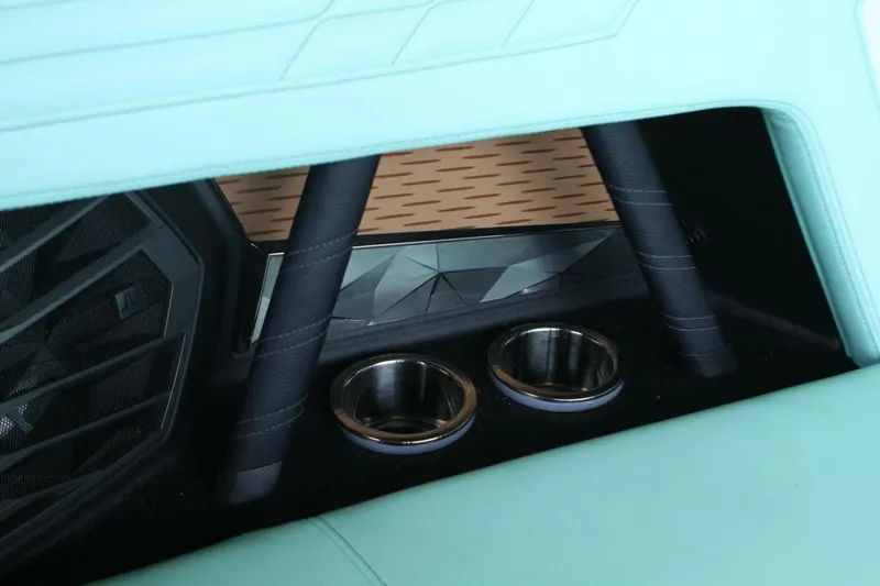  Yacht Photos Pics 2024 Nautique Super Air Nautique G23 interior with cup holders and speaker detail.