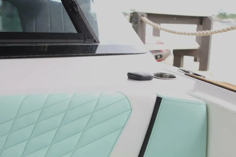  Yacht Photos Pics 2024 Nautique Super Air Nautique G23 interior with mint upholstery and cup holder.