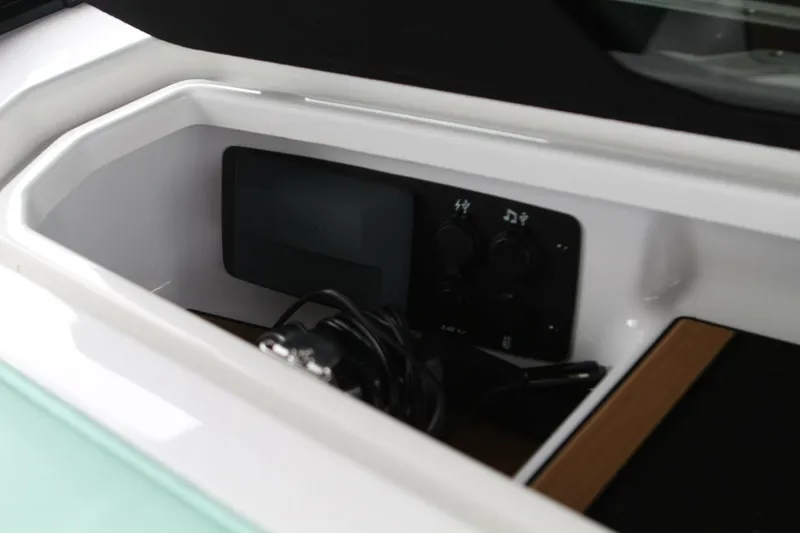  Yacht Photos Pics 2024 Nautique Super Air Nautique G23 storage compartment with control panel and cables.