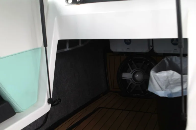  Yacht Photos Pics 2024 Nautique Super Air Nautique G23 interior storage with speaker and trash bin.