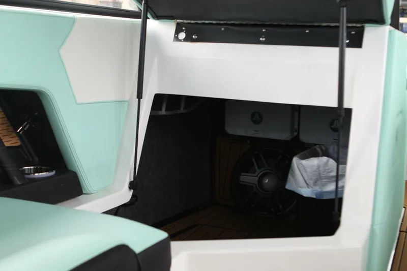  Yacht Photos Pics 2024 Nautique Super Air Nautique G23 interior storage compartment with speaker system.