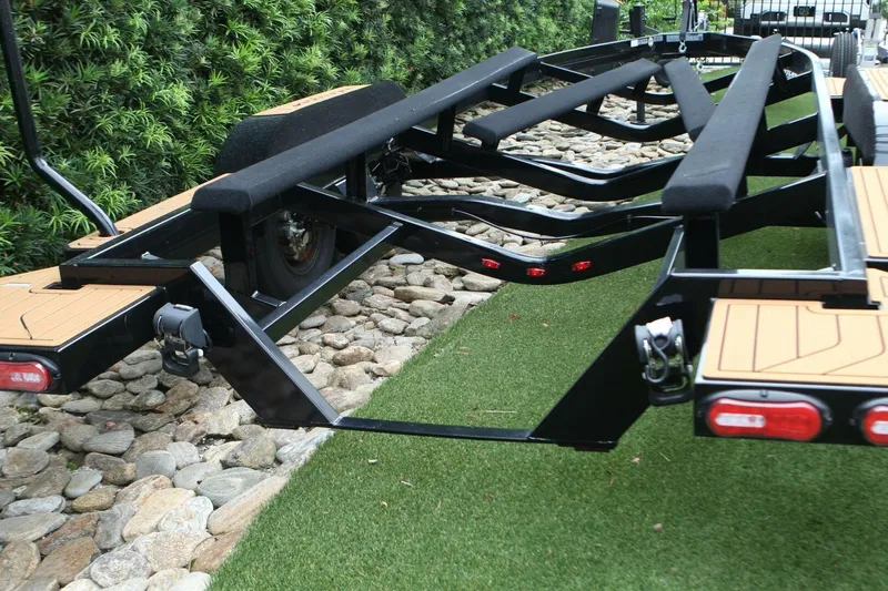  Yacht Photos Pics Trailer for 2024 Nautique Super Air Nautique G23 on grass and stones.