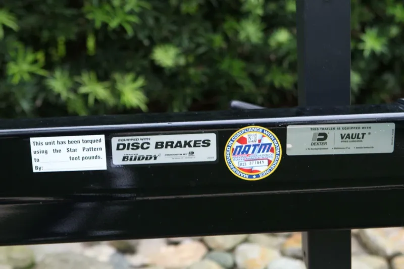  Yacht Photos Pics Trailer detail for 2024 Nautique Super Air Nautique G23 with disc brakes and compliance stickers.