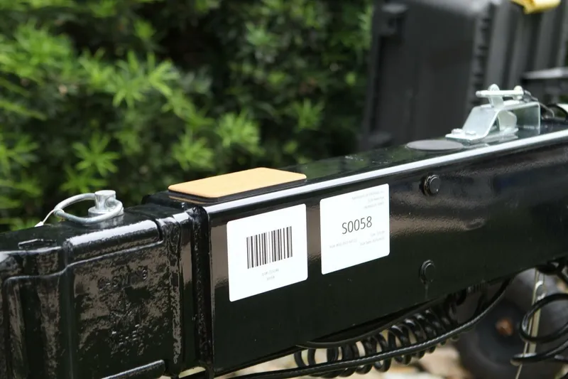  Yacht Photos Pics Close-up of a 2024 Nautique Super Air Nautique G23 trailer hitch with barcode and label.