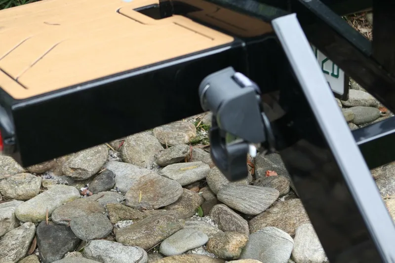  Yacht Photos Pics 2024 Nautique Super Air Nautique G23 trailer hitch detail on rocky ground.