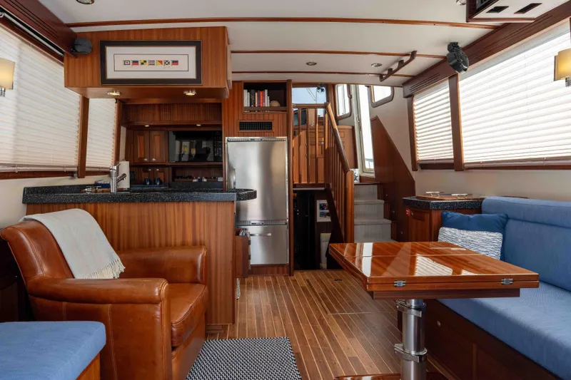 Take 2 Yacht Photos Pics Luxurious interior of a 2015 Nordic Tug 44 yacht with wood finishes and modern amenities.