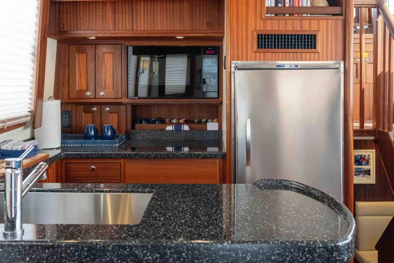 Take 2 Yacht Photos Pics Luxurious 2015 Nordic Tug 44 yacht kitchen with wood cabinetry and modern appliances.