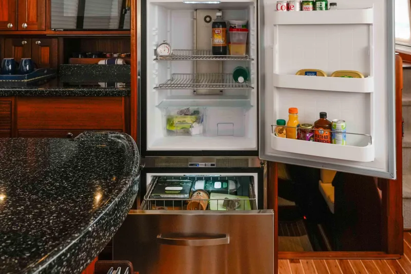 Take 2 Yacht Photos Pics Open refrigerator in 2015 Nordic Tug 44 yacht kitchen, stocked with beverages and condiments.