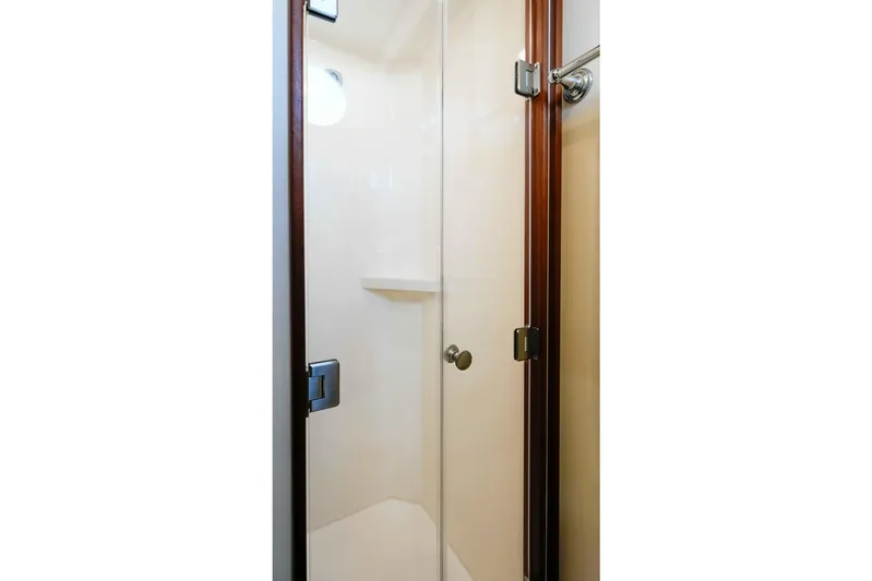 Take 2 Yacht Photos Pics Shower enclosure in 2015 Nordic Tug 44 yacht, featuring glass door and wooden frame.